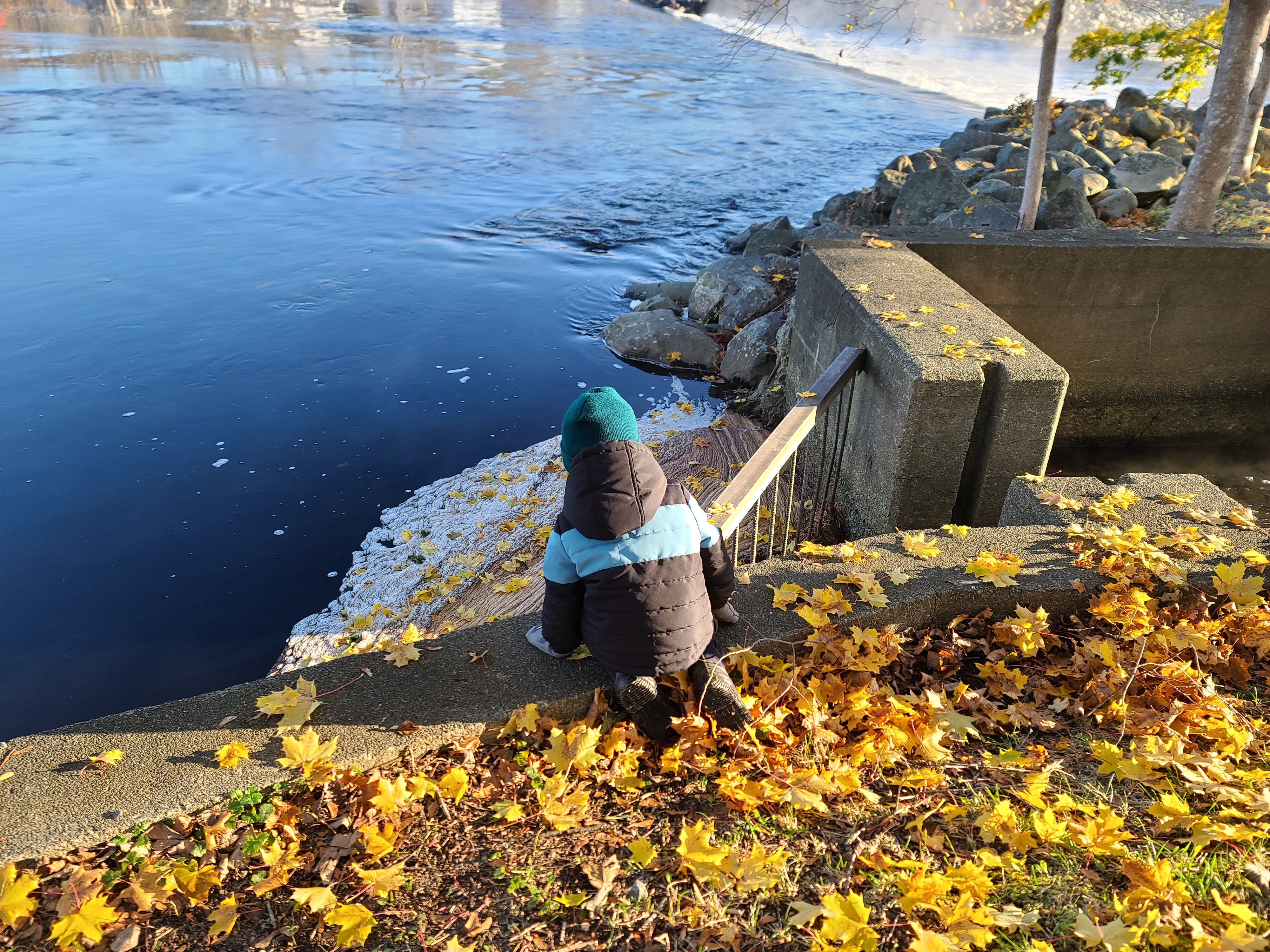 elementary child watching water flow